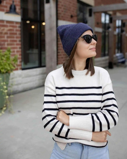 Denim blue cuffed knit beanie worn with sunglasses and a striped sweater