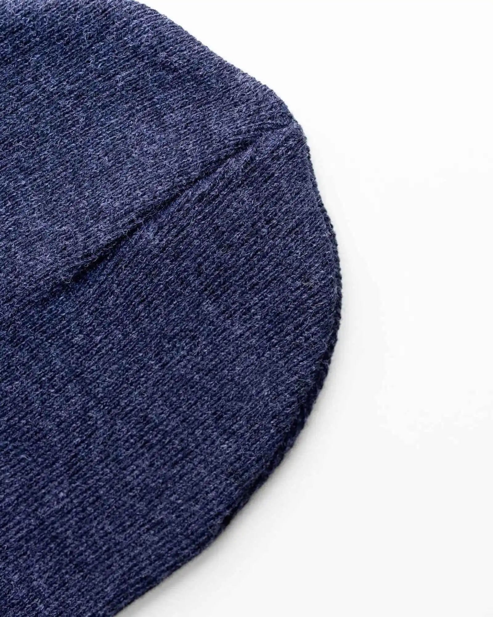 Denim blue knit beanie side view with folded cuff edge