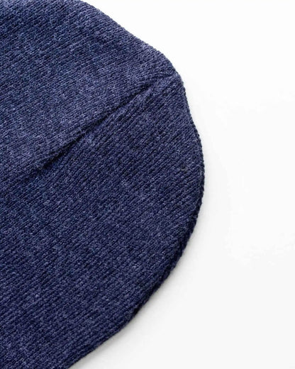 Denim blue knit beanie side view with folded cuff edge