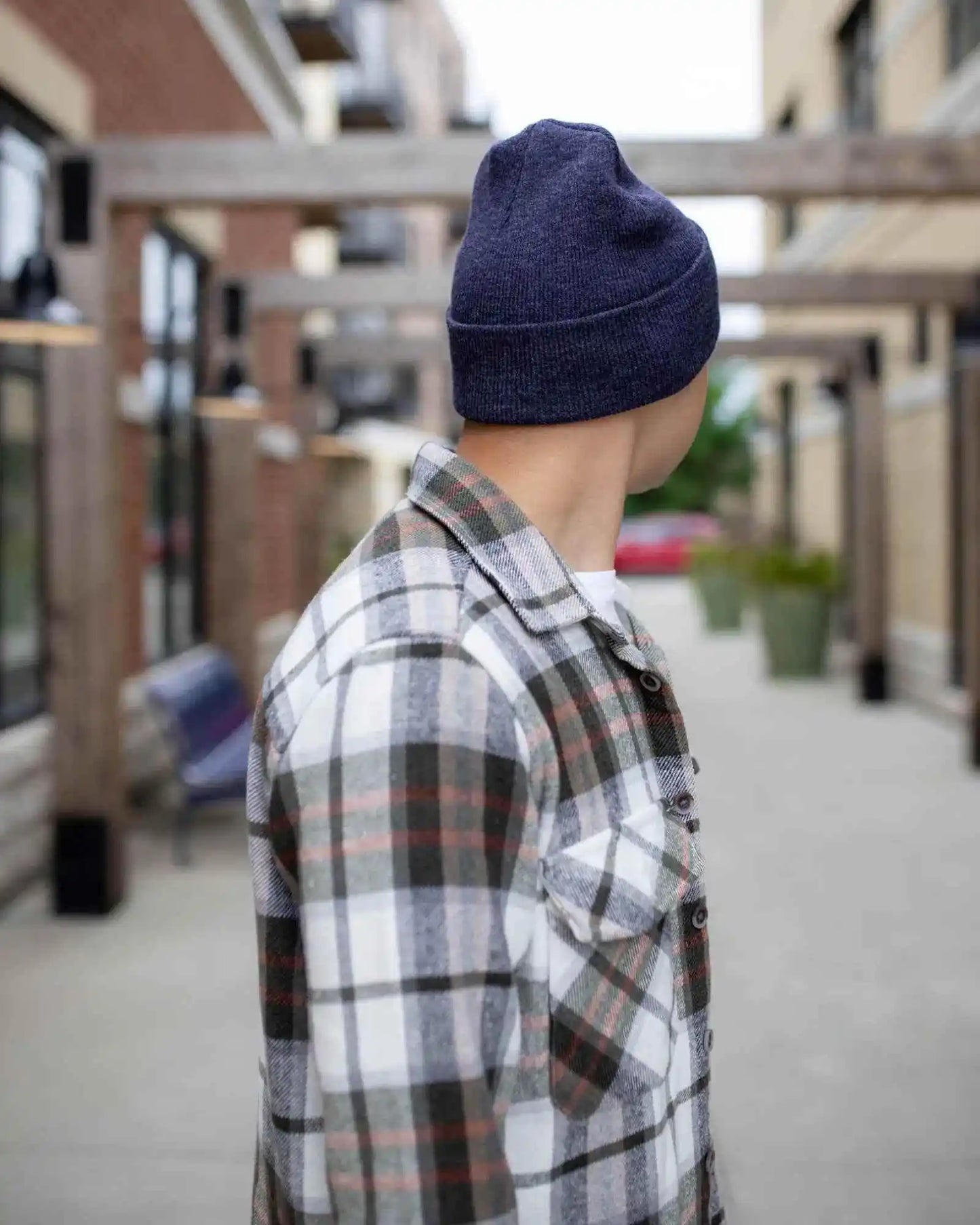 Denim blue knit beanie on person, back view