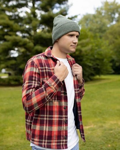 Forest green cuffed knit beanie worn on head