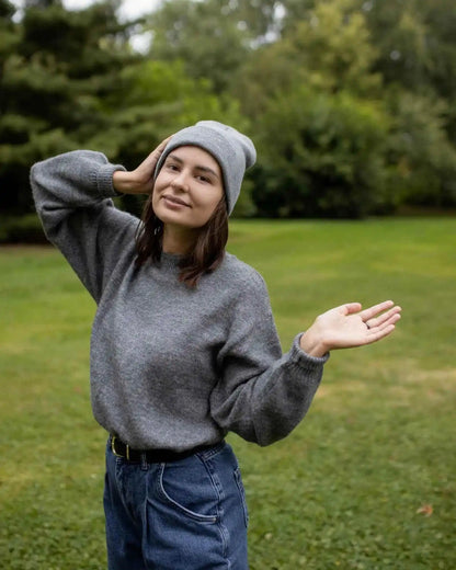 Gray cuffed knit beanie with textured knit and folded edge visible