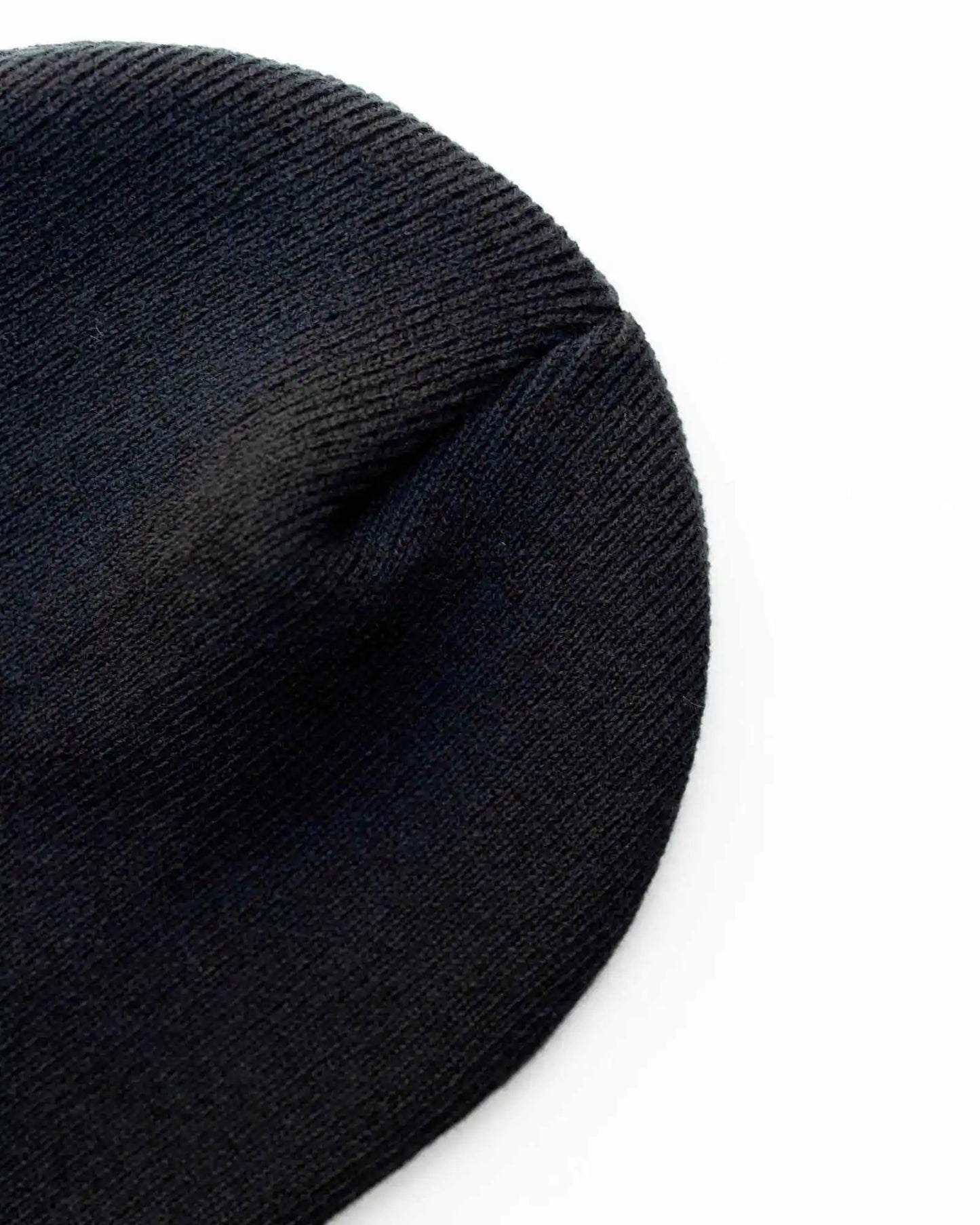 Midnight black knit beanie close-up, textured fabric