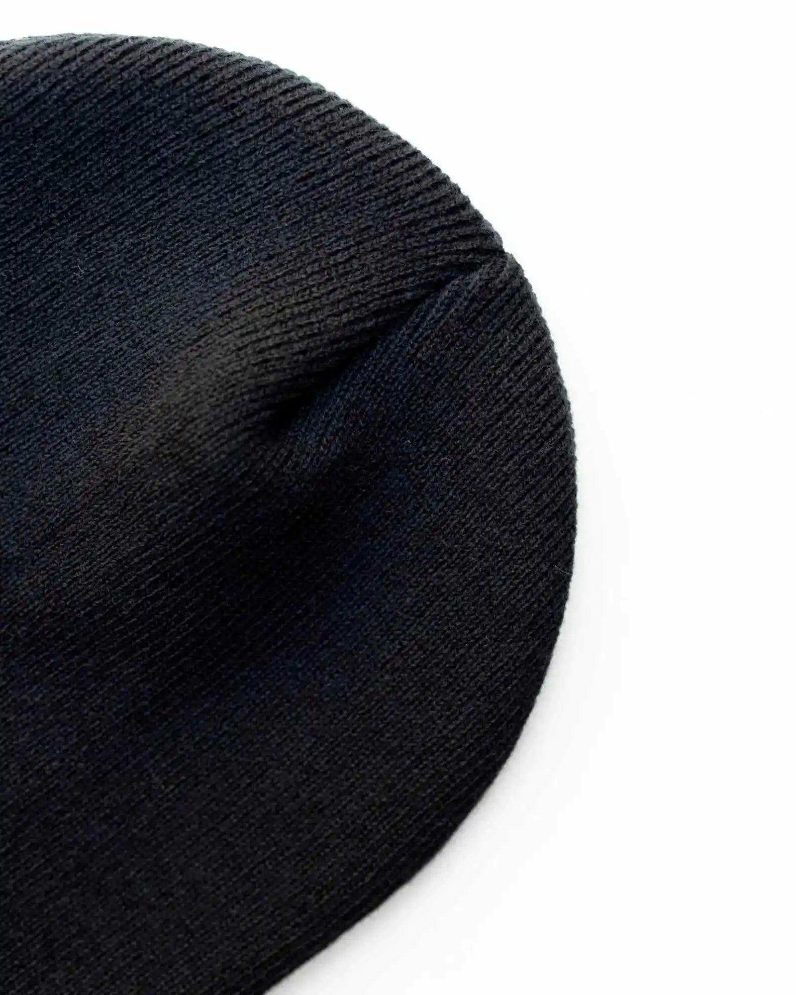 Midnight black knit beanie close-up, textured fabric