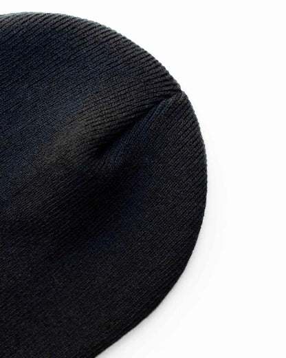 Midnight black knit beanie close-up, textured fabric