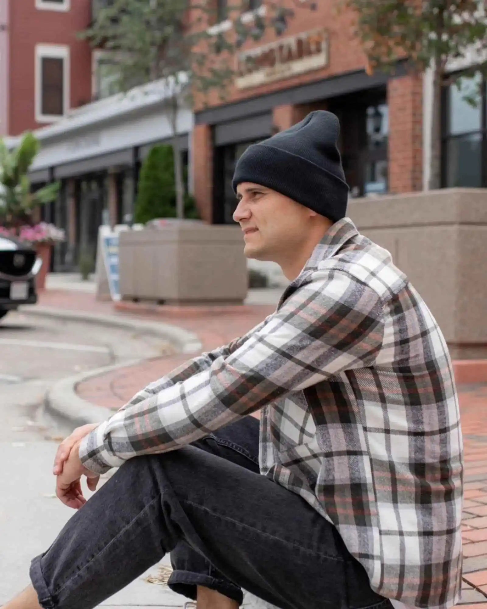 Midnight black cuffed knit beanie on person