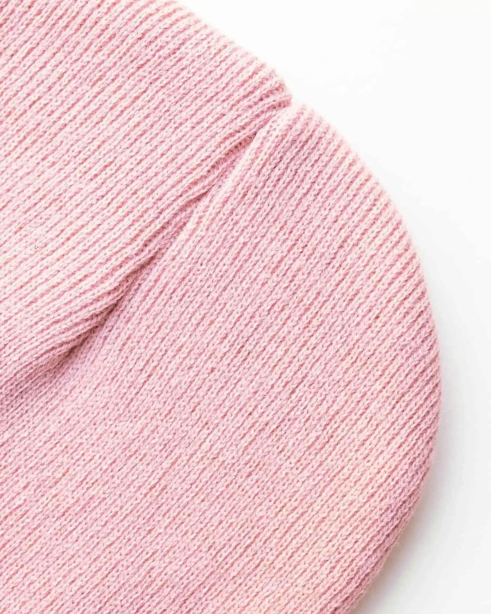 Pink knit beanie crown with visible seam and fine ribbing detail