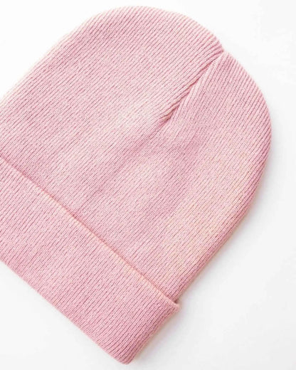 Pink ribbed knit beanie with folded cuff edge and close-up knit texture