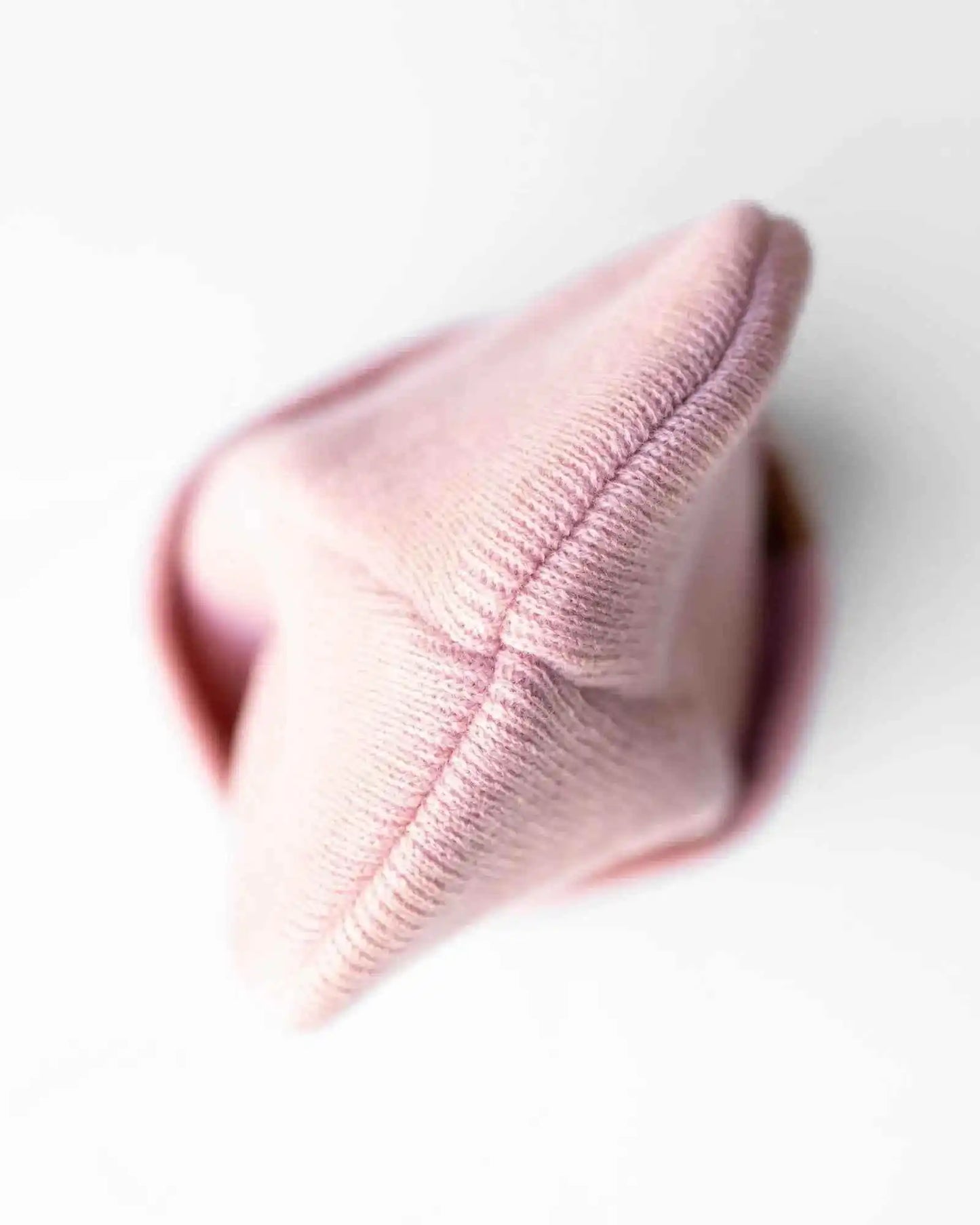 Pink ribbed knit beanie with folded cuff and detailed knit texture