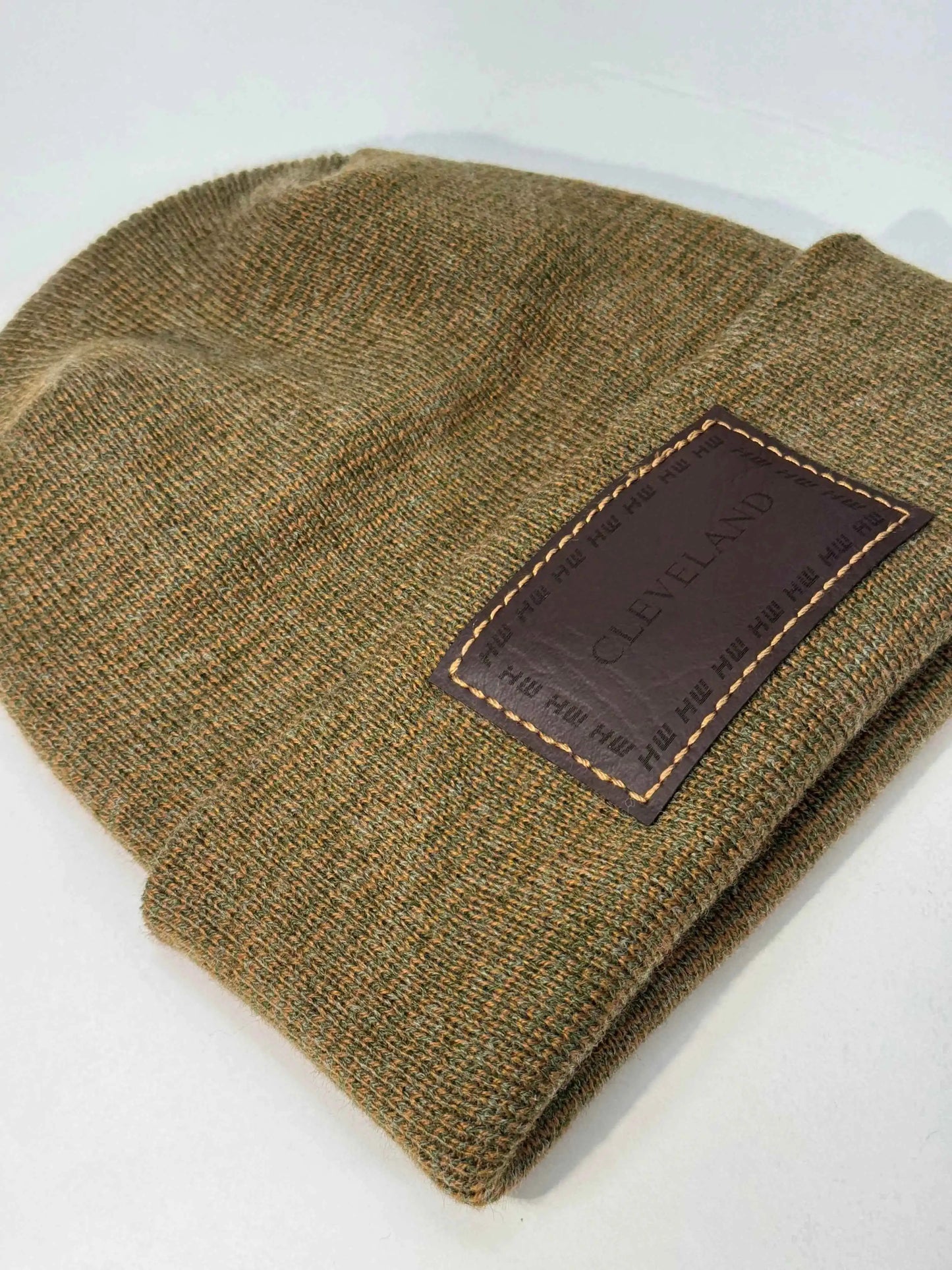 Brown knit beanie folded cuff with Cleveland logo patch and stitched border