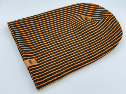 Black and orange striped knit beanie with folded cuff and tag patch