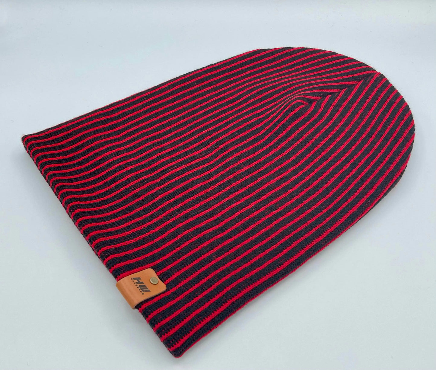 Cuffed beanie with red-and-black wide ribbed stripes and leather logo patch