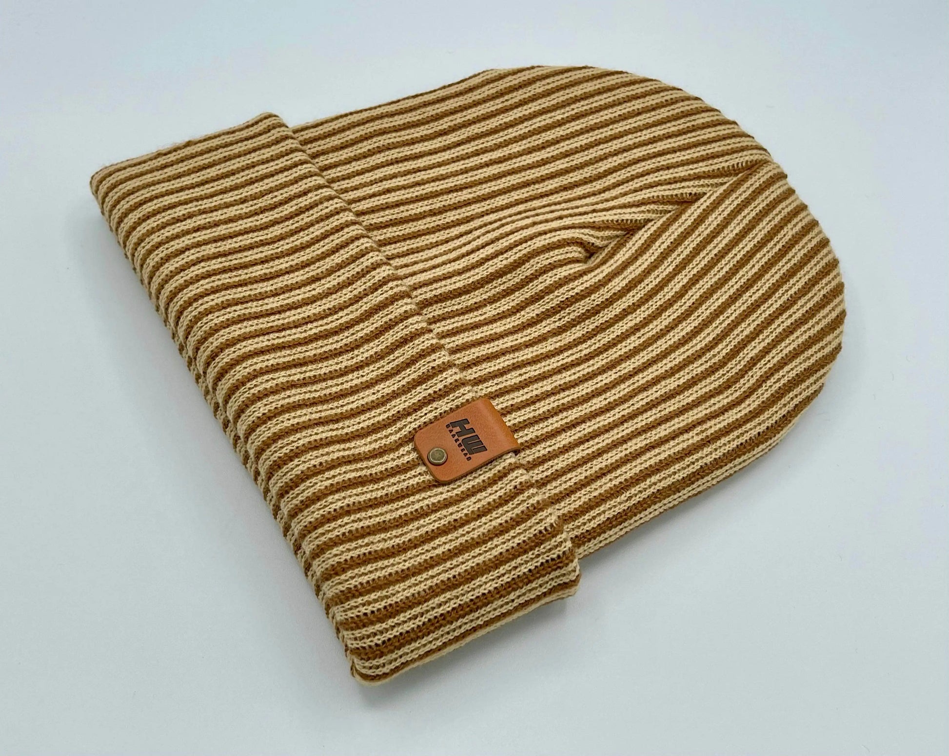 Brown and beige striped ribbed beanie with leather logo patch