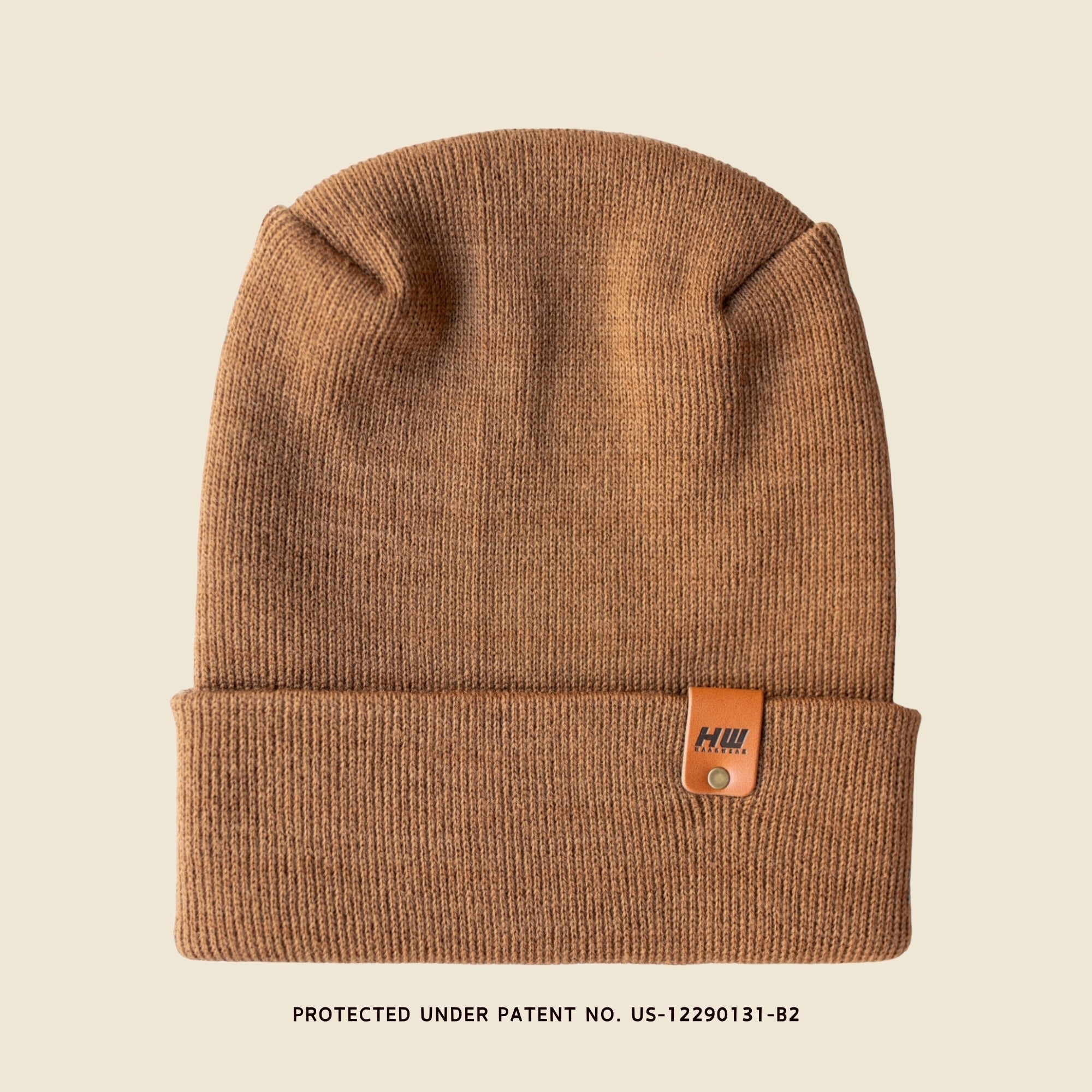 Brown H-Stitch beanie with a leather patch on a beige background