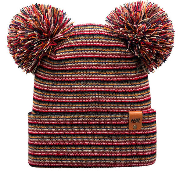 Multicolored striped beanie with pom-poms on a white background