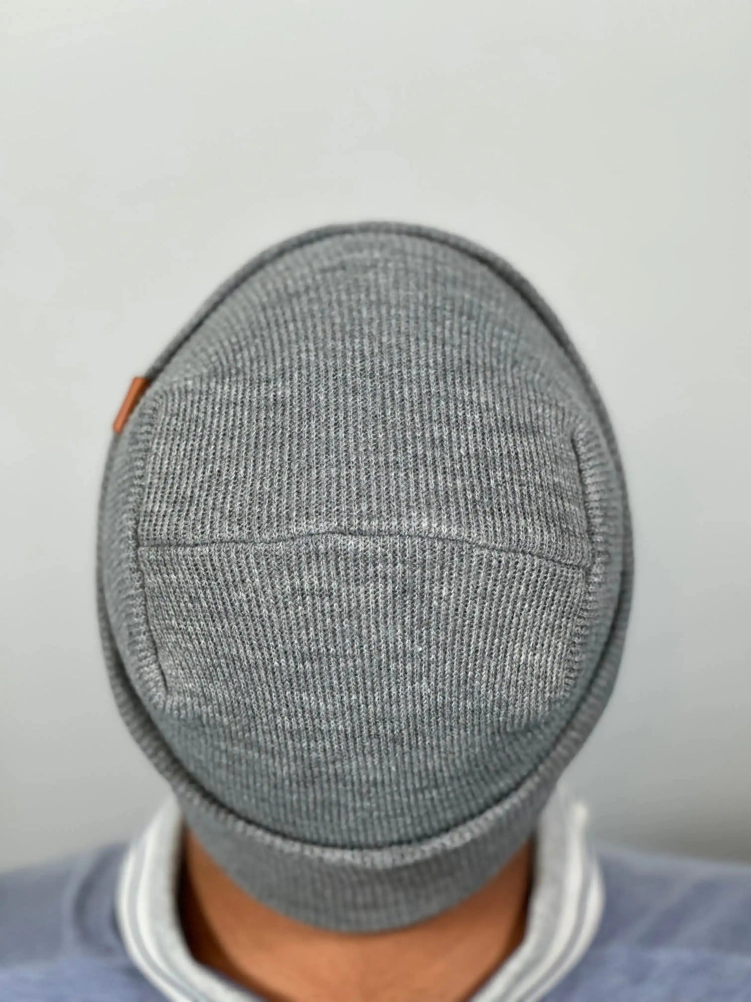 Person wearing a gray knit h stitch beanie that is made in USA by Haakwear. 