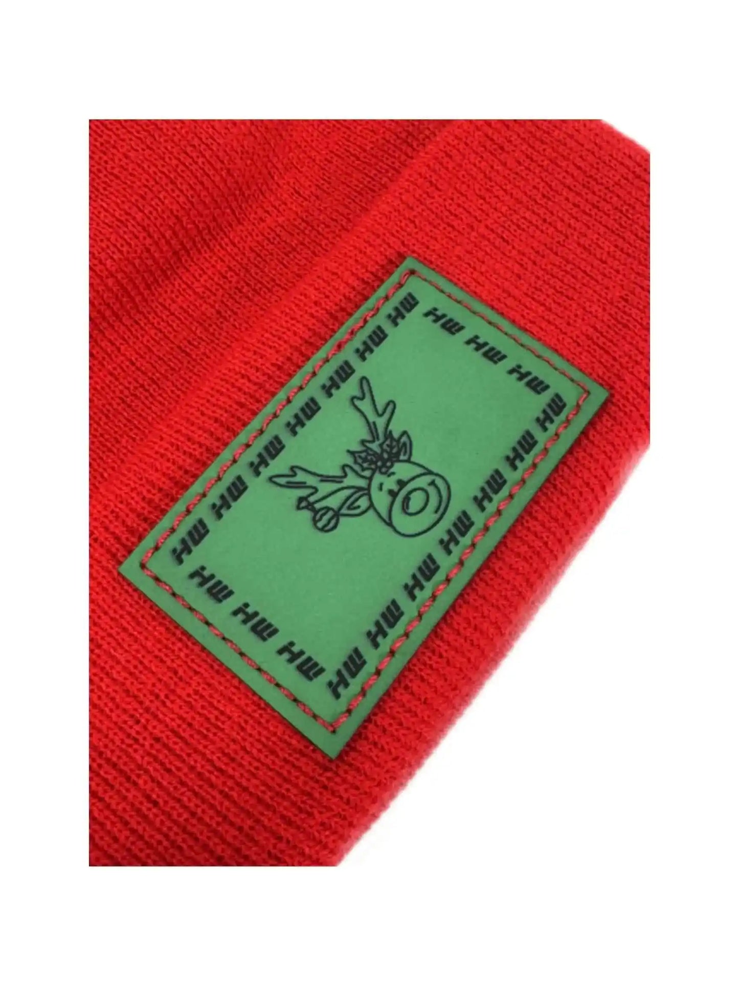 Red knit beanie with green reindeer label patch close-up