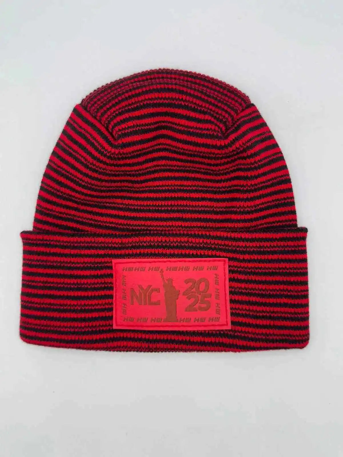 Cuffed beanie in red and black striped knit with front NYC 25 logo patch