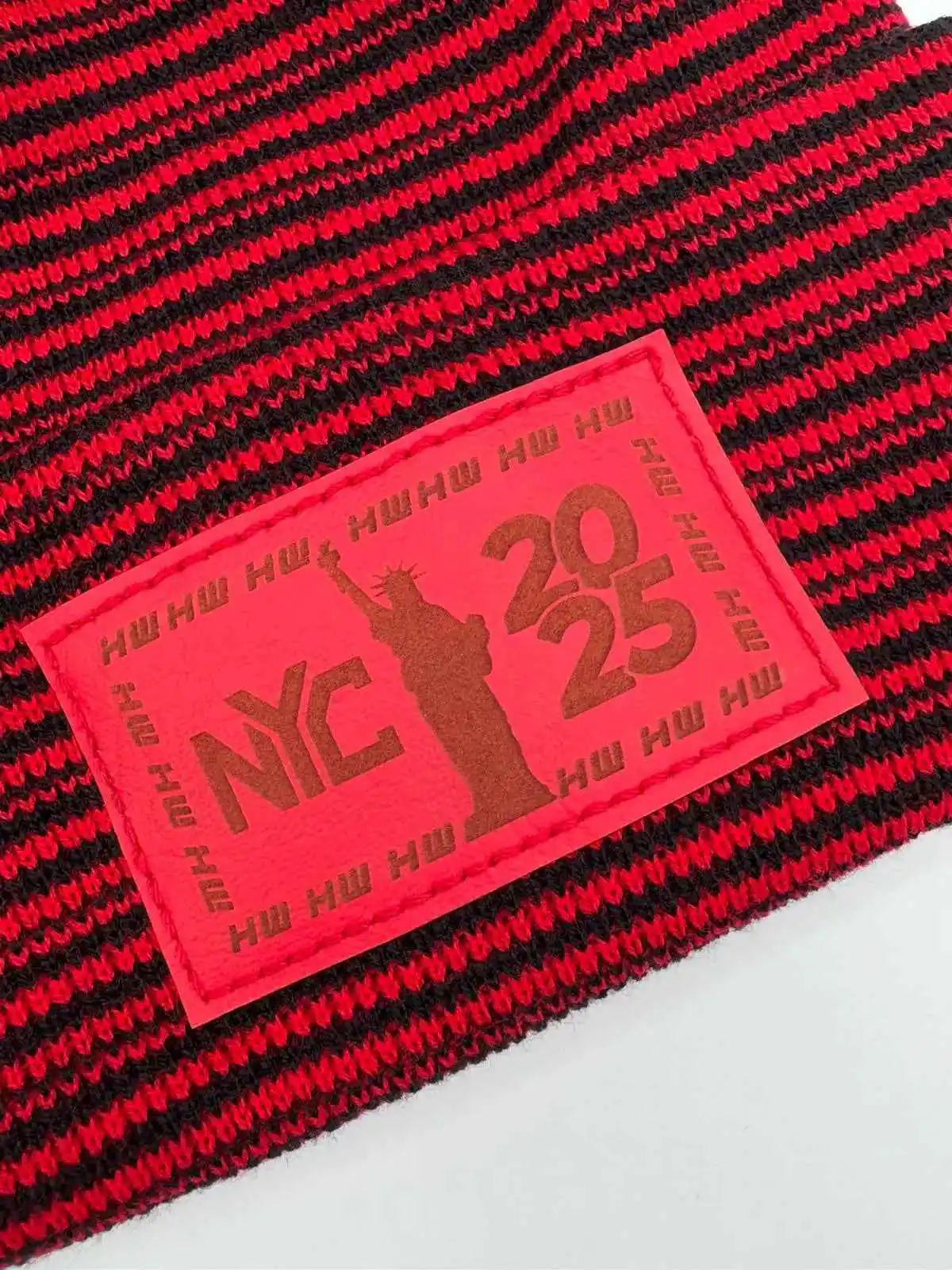 Cuffed beanie knit with black and red stripes, red NYC 25 patch label