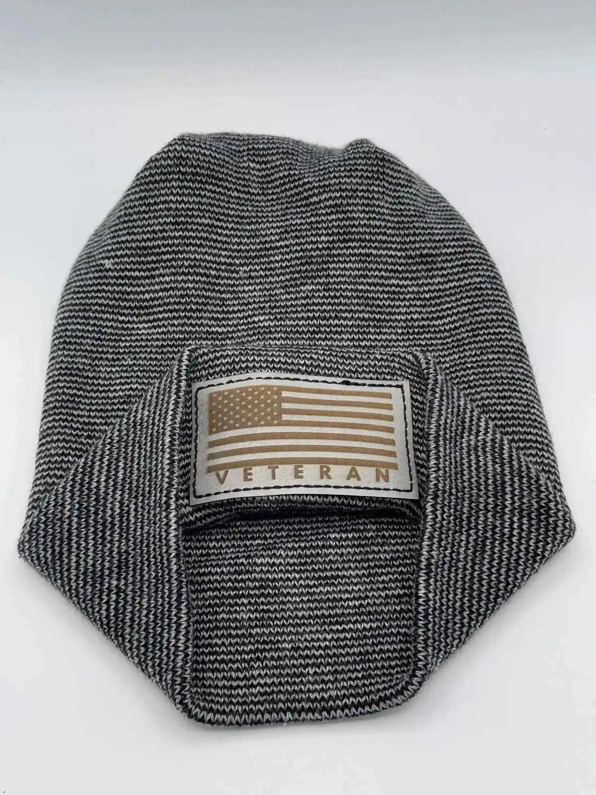 Black-and-white striped cuffed beanie with rectangular Veteran flag patch.