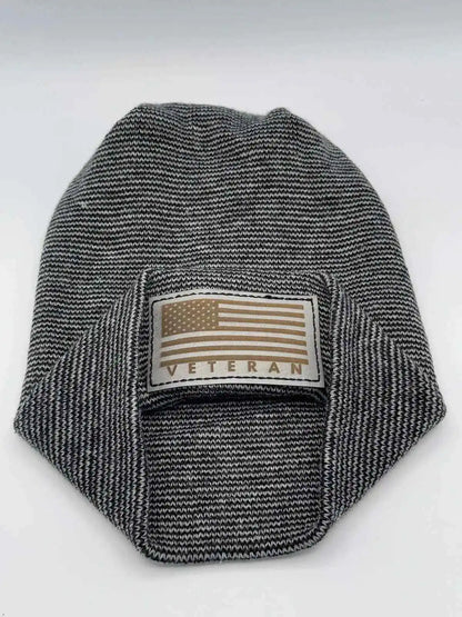 Black-and-white striped cuffed beanie with rectangular Veteran flag patch.