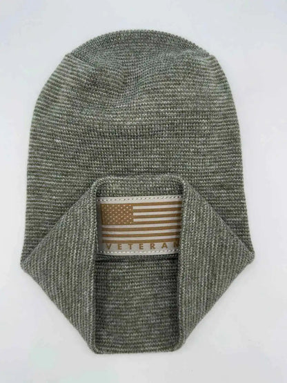 Olive-gray knit cuffed beanie with rectangular Veteran patch.