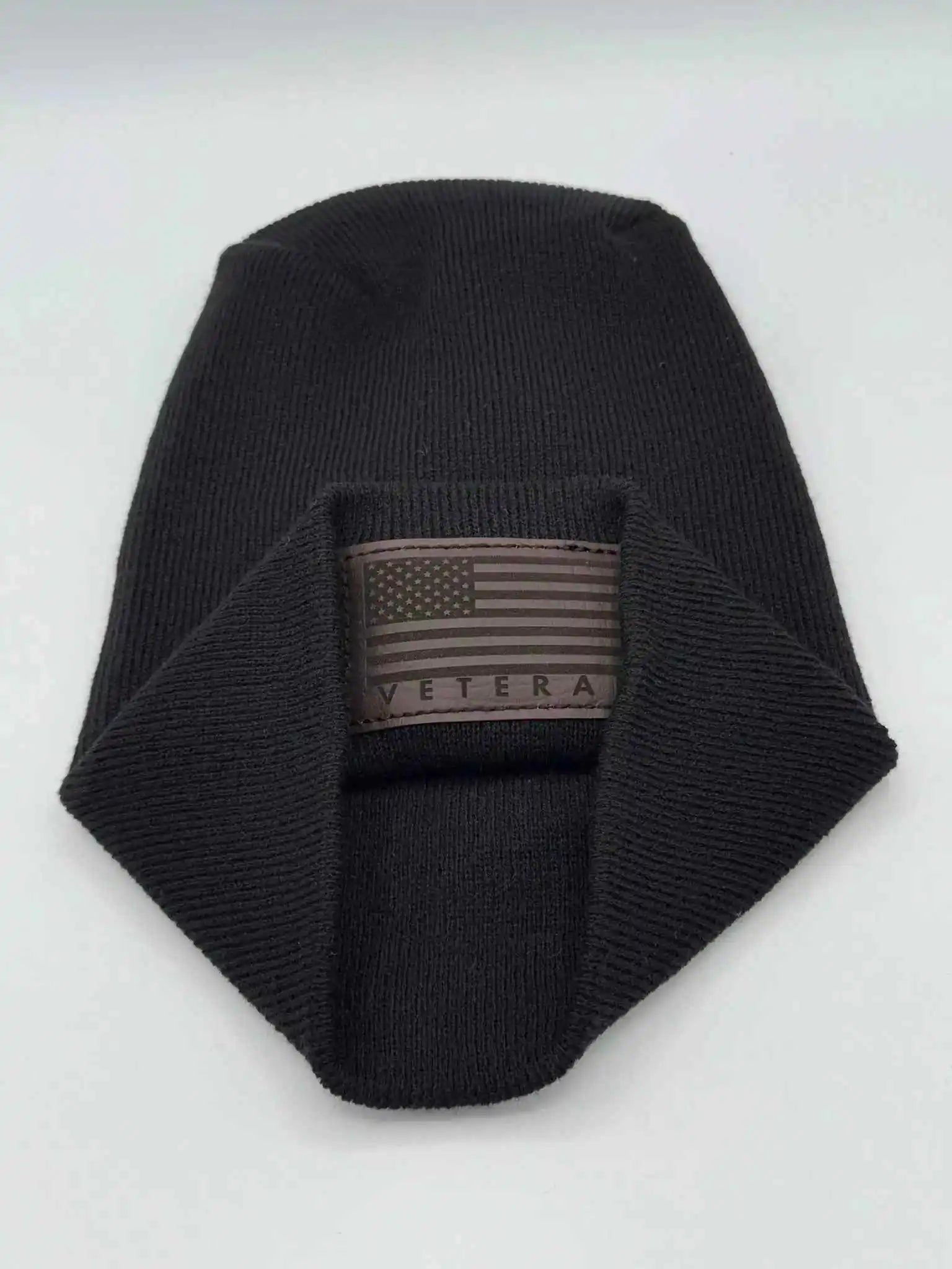 Cuffed knit beanie in black with a Veterans flag patch on the front cuff