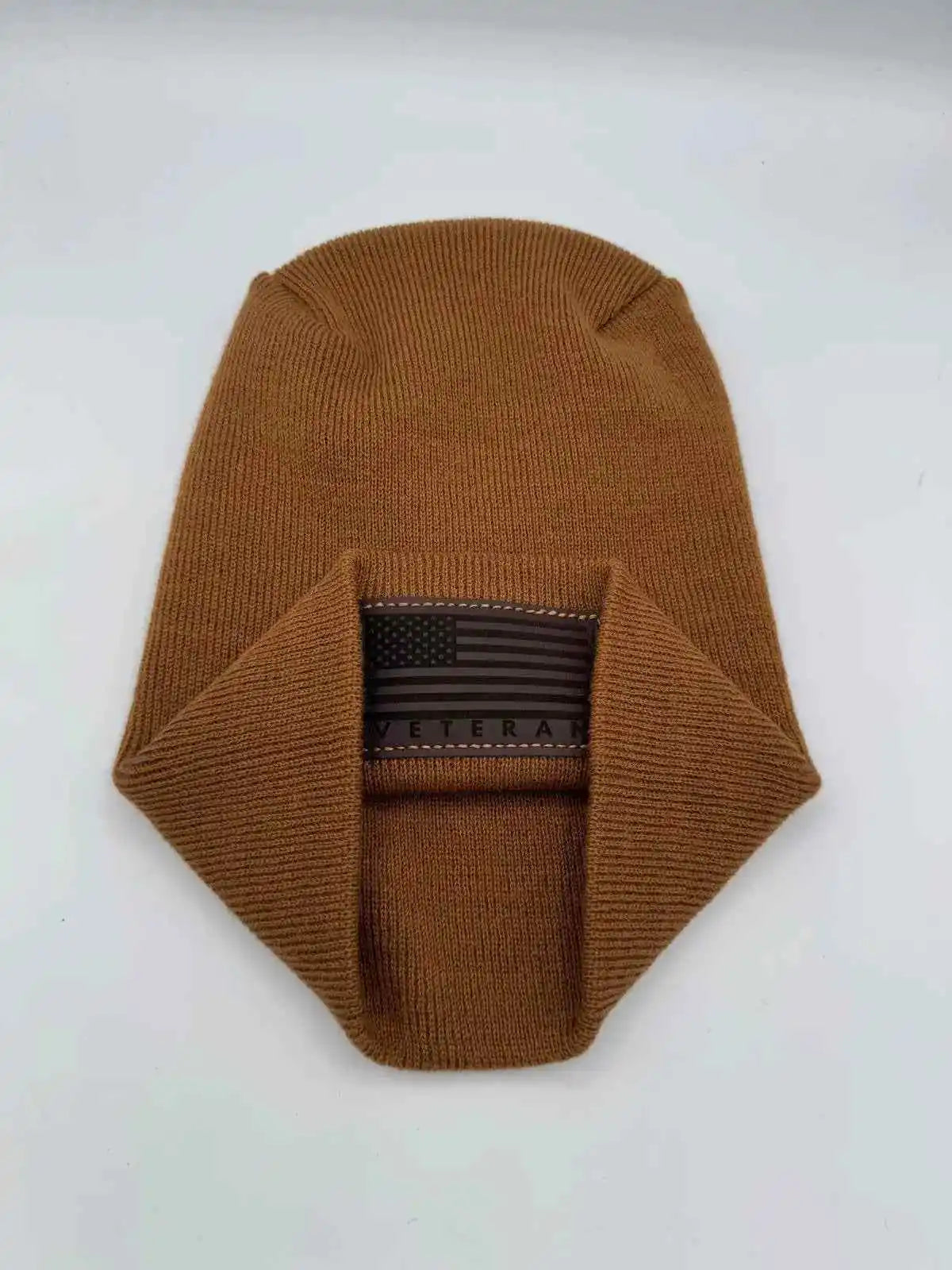 Medium brown knit cuffed beanie with rectangular Veteran flag patch.