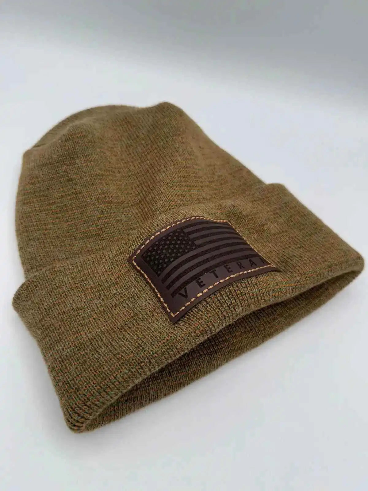 Cuffed knit beanie in olive-brown with a Veterans flag patch on the cuff