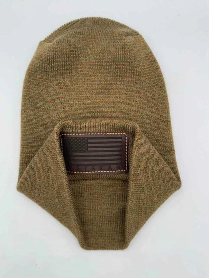 Olive knit cuffed beanie with rectangular Veteran patch on cuff.