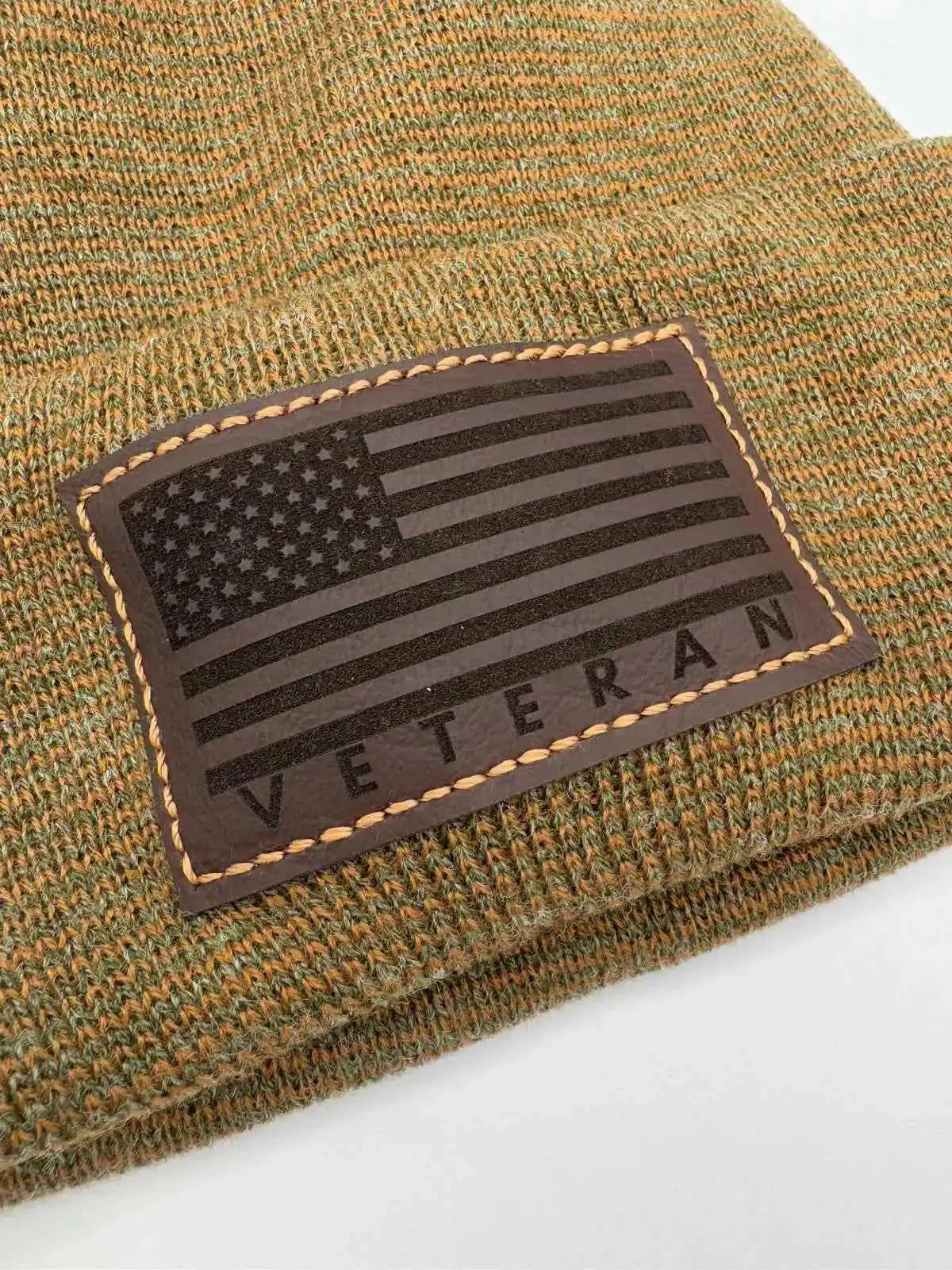 Green tweed knit cuffed beanie with rectangular Veteran flag patch.