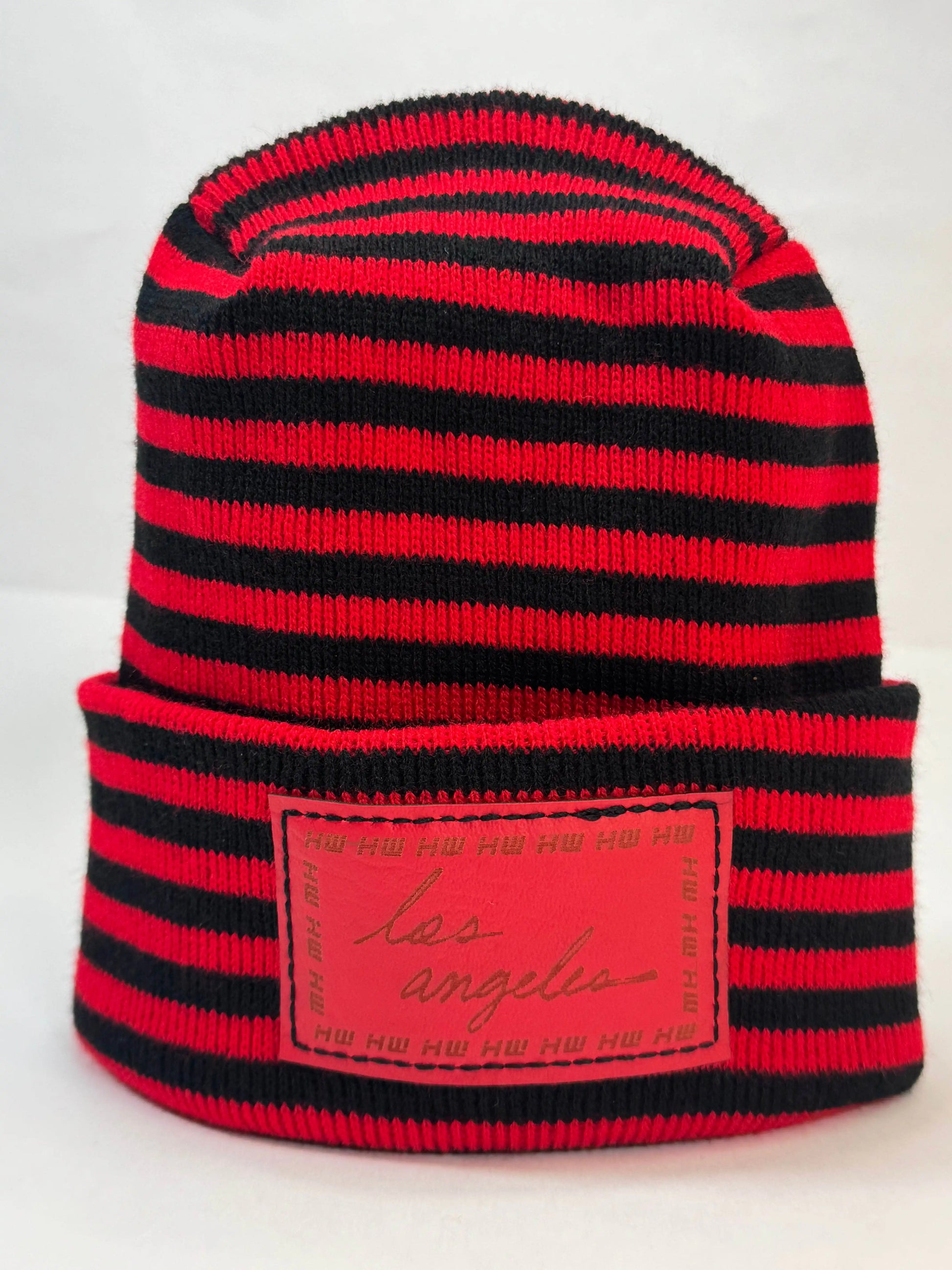 Black and red striped beanie with fold cuff and rectangular front logo patch