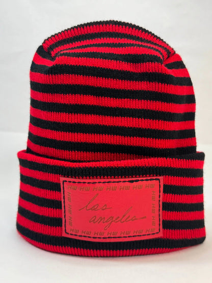 Black and red striped beanie with fold cuff and rectangular front logo patch