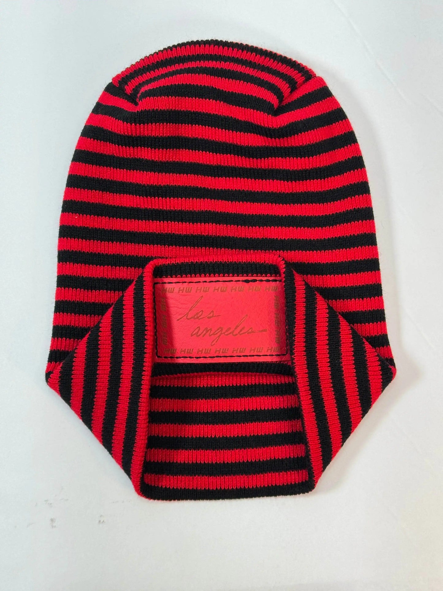 Striped black and red beanie with front logo patch and folded cuff