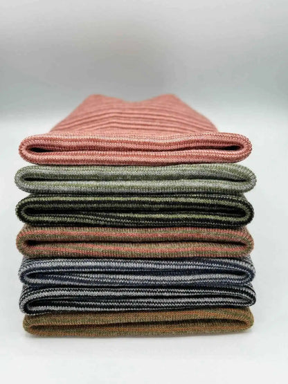 Stack of striped cuff knit beanies in assorted colors