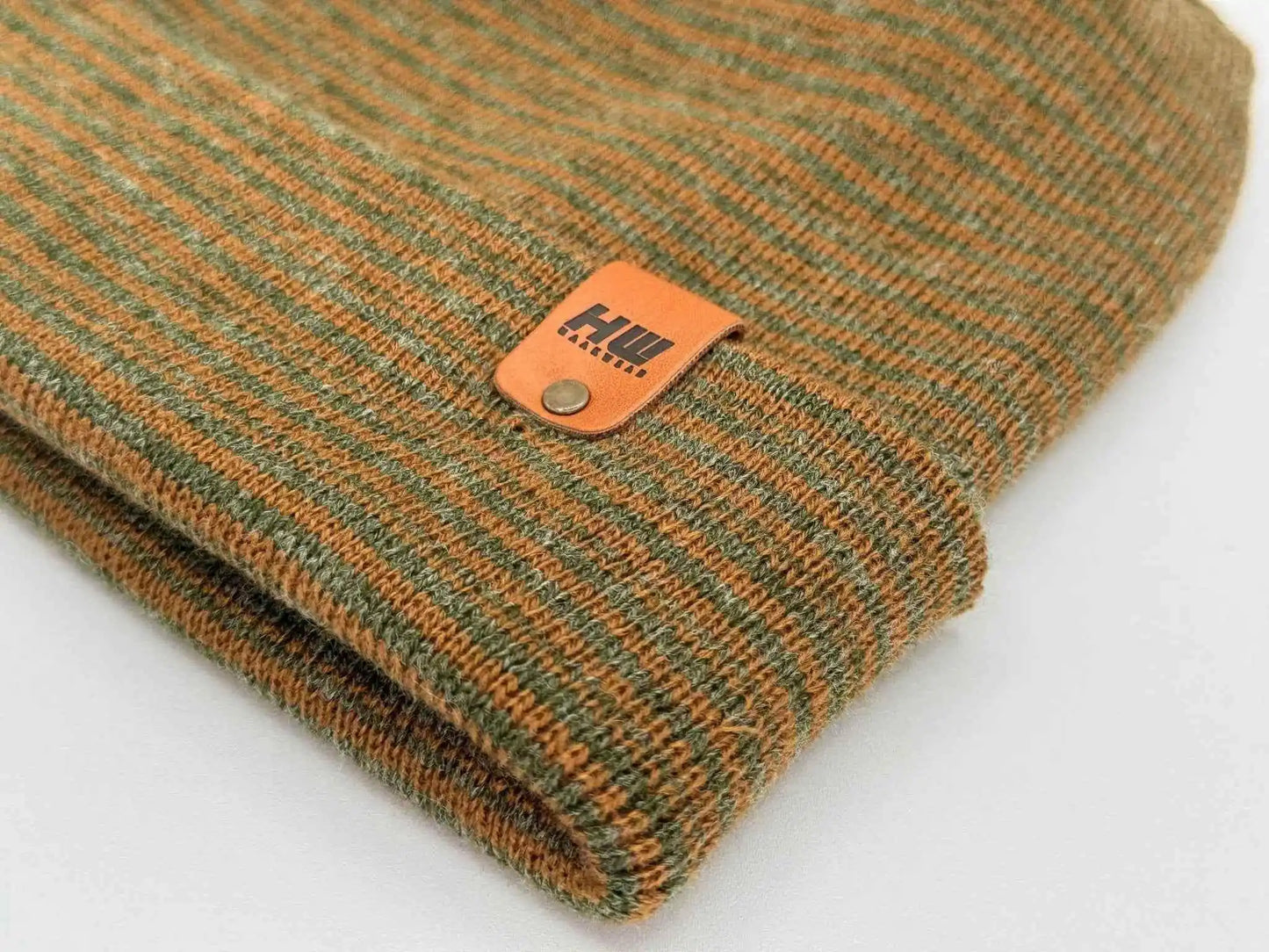 Brown and green contrast beanie with ribbed knit and orange logo patch on cuff