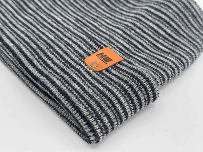 Striped cuffed beanie detail, gray and dark blue knit with orange logo patch