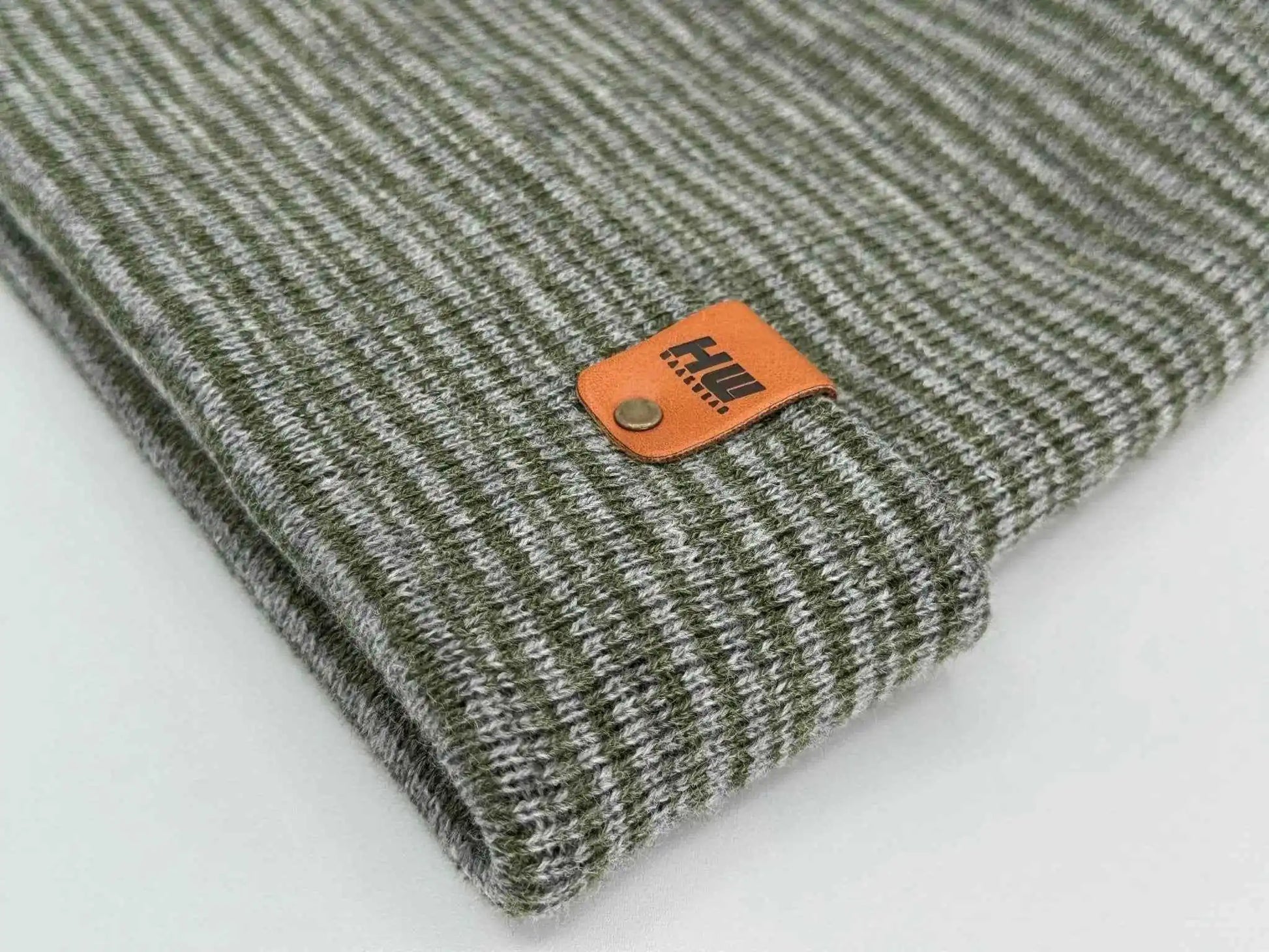 Ribbed knit beanie with folded brim and orange square logo patch detail
