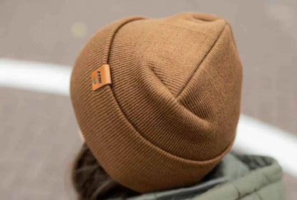 Camel brown knit beanie rolled back view, showing side logo patch