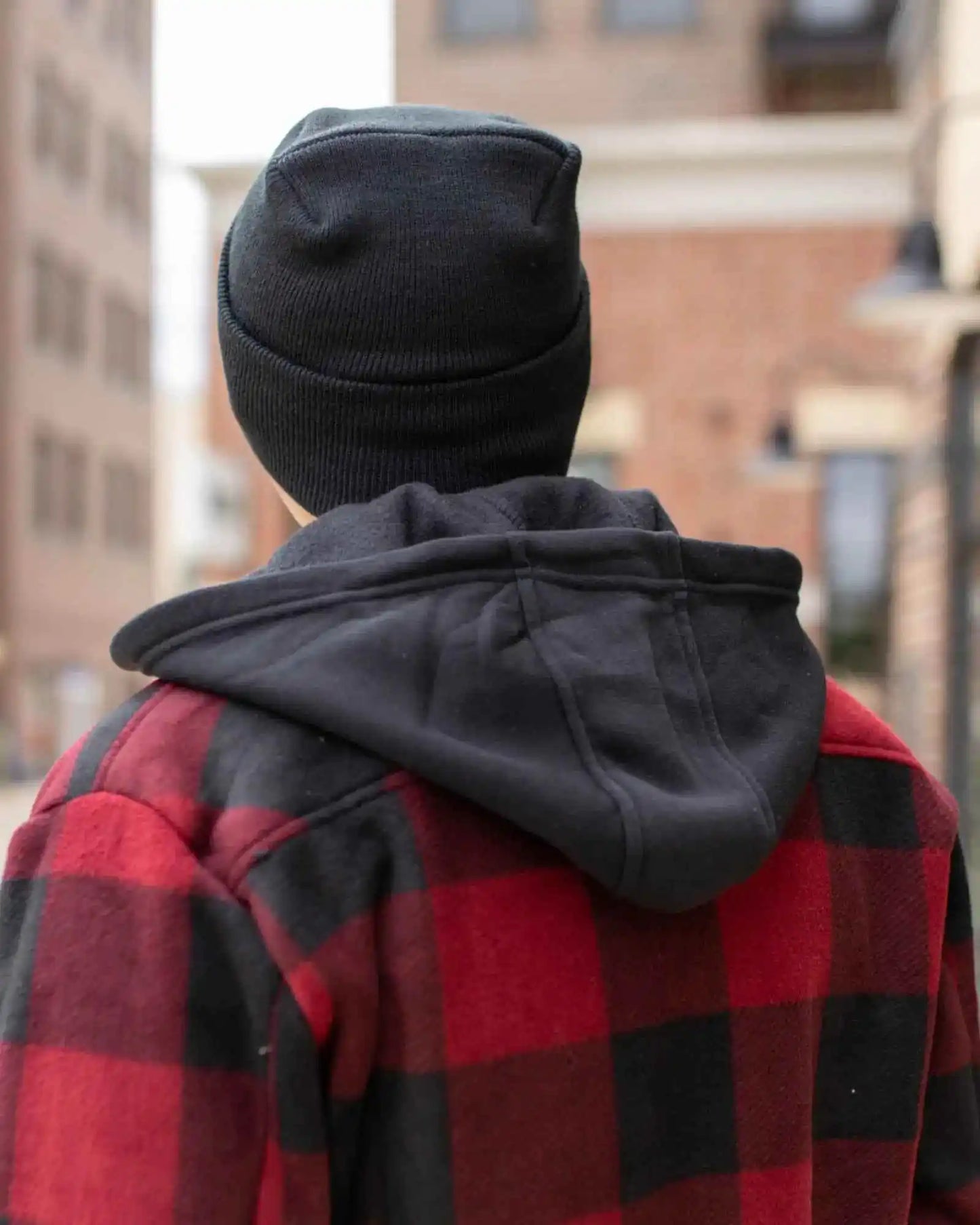 Charcoal black knit cuff beanie viewed from back on person