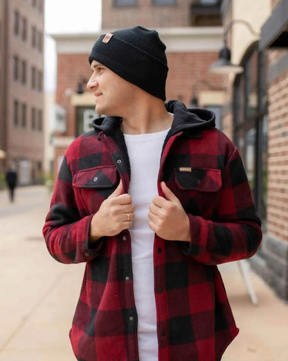 Charcoal black cuff beanie worn on person, front three-quarter view