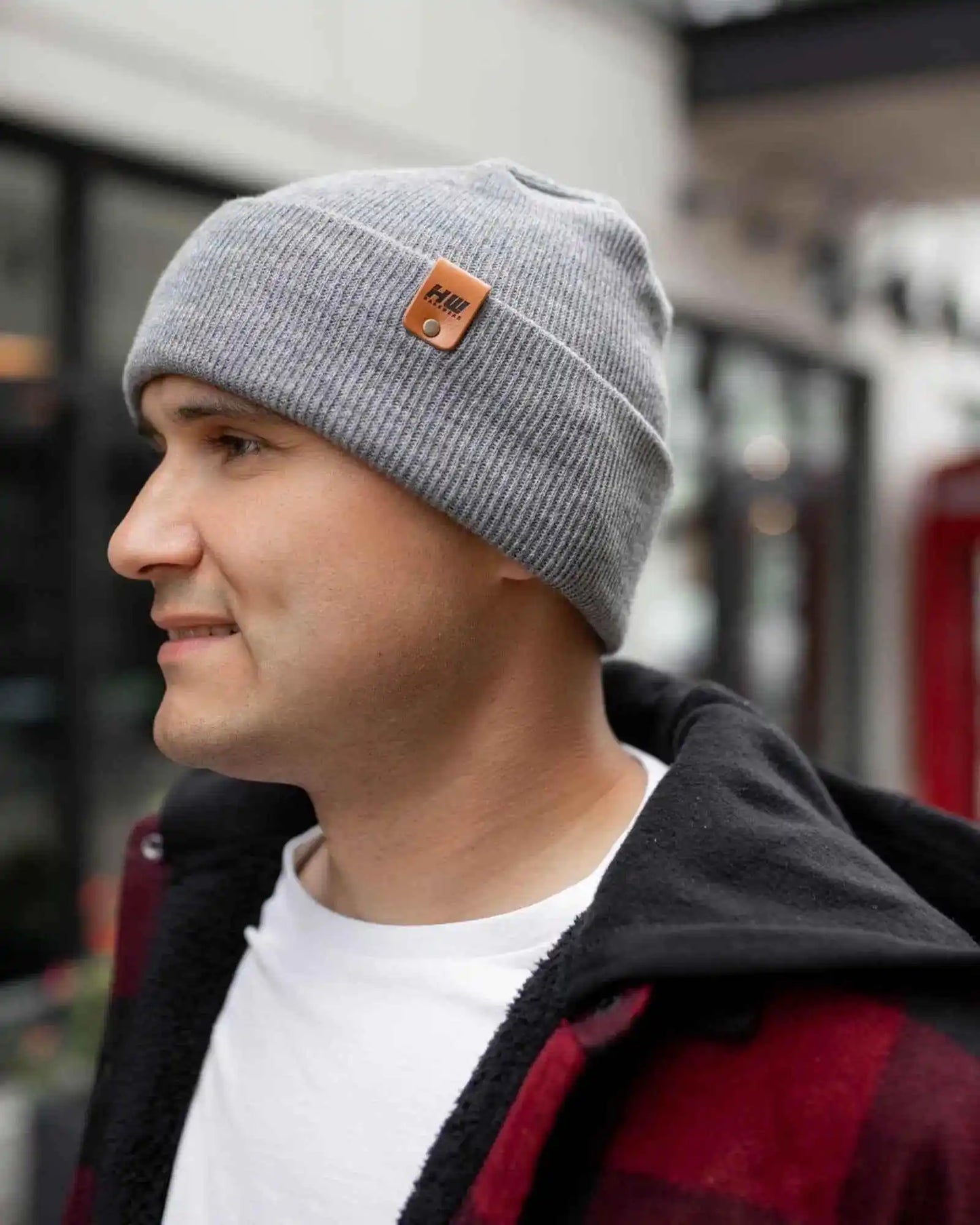 Gray beanie with foldover cuff, angled side view, and small square logo patch