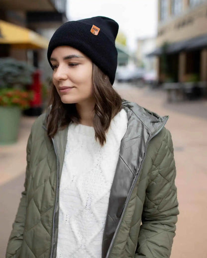 Midnight black cuffed beanie with knit texture and rectangular logo patch