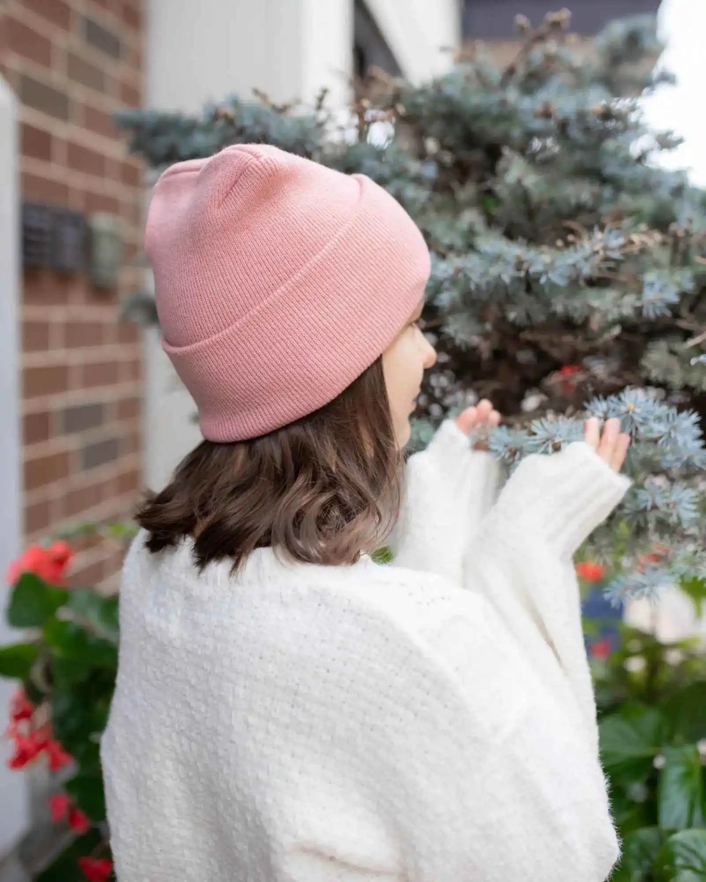 Pearl pink cuff beanie worn with a folded knit top
