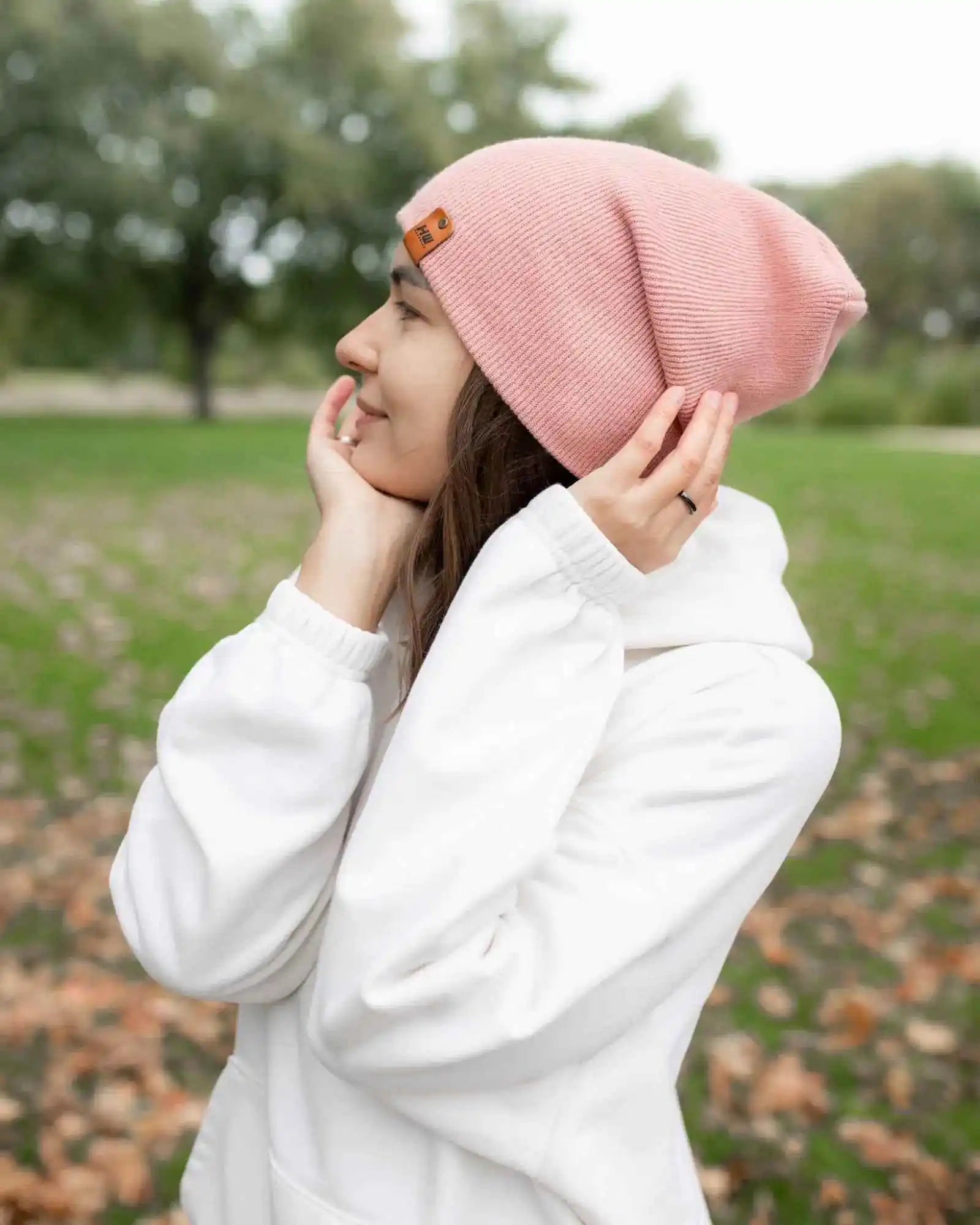 Pearl pink cuff beanie with fold-over top and small square logo patch