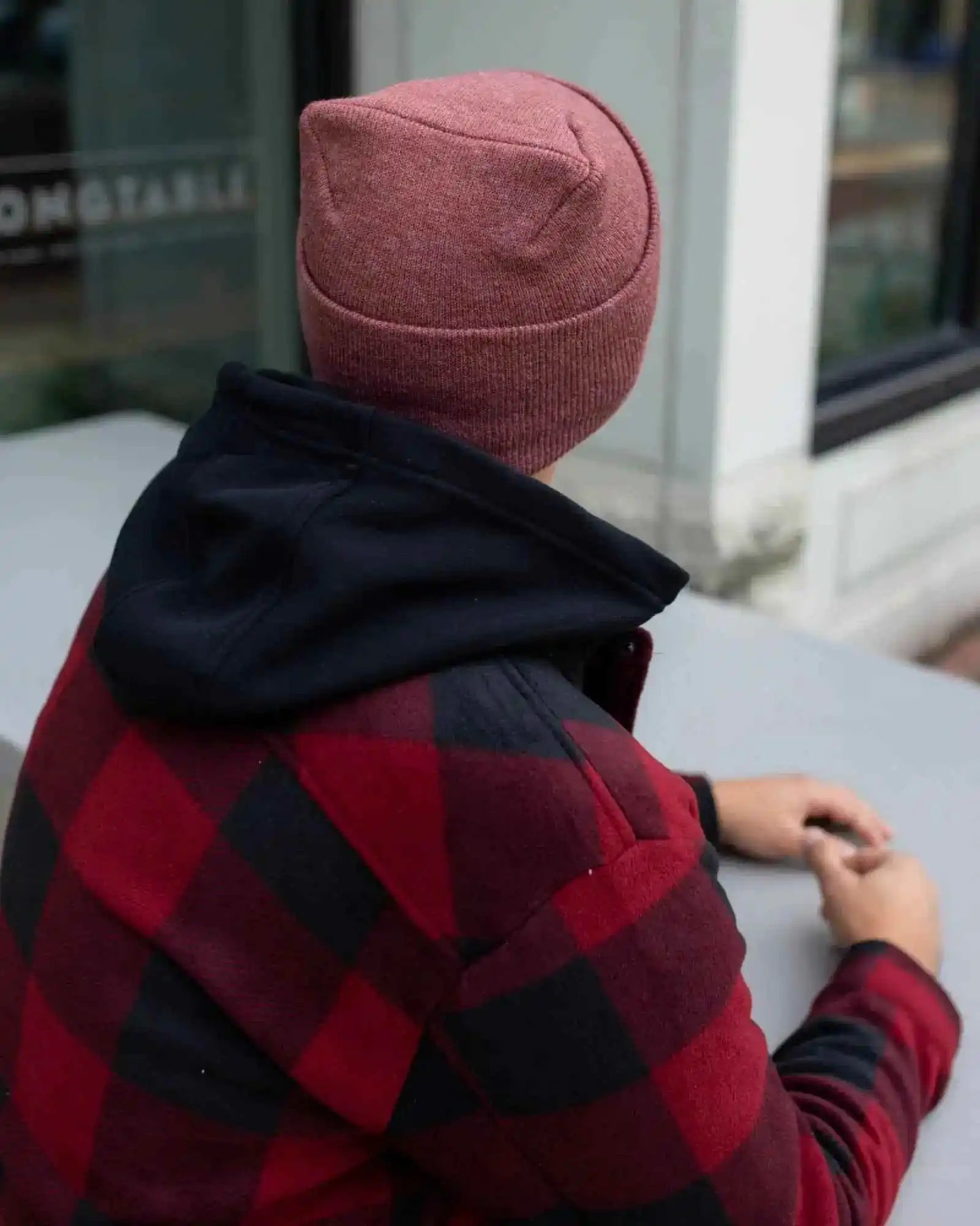 Cuffed knit beanie in rusty burgundy, seam detail on back and top