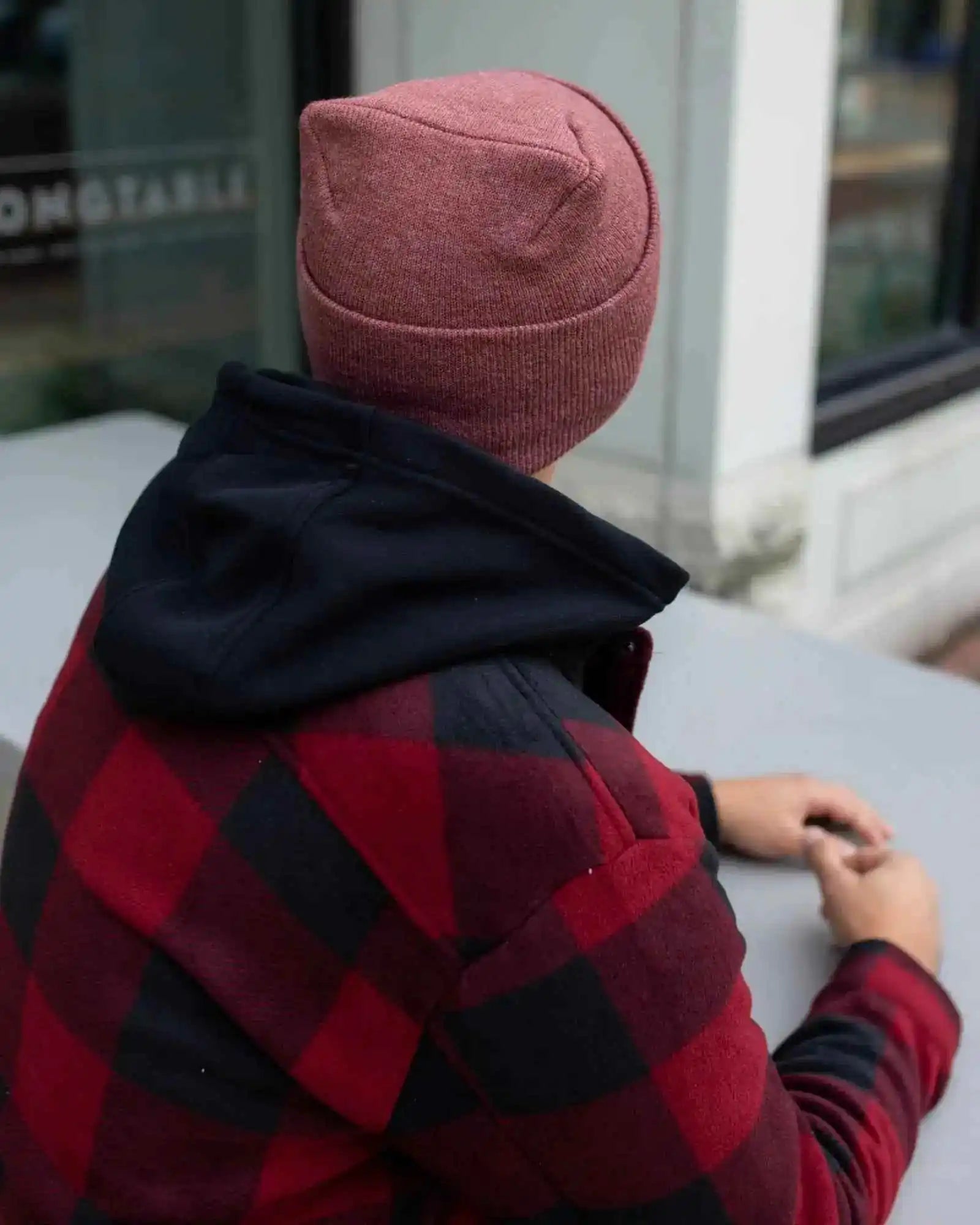 Cuffed knit beanie in rusty burgundy, seam detail on back and top