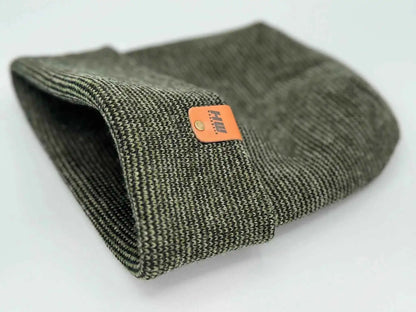 Cuffed knit beanie with dark green textured knit and orange rectangular logo patch