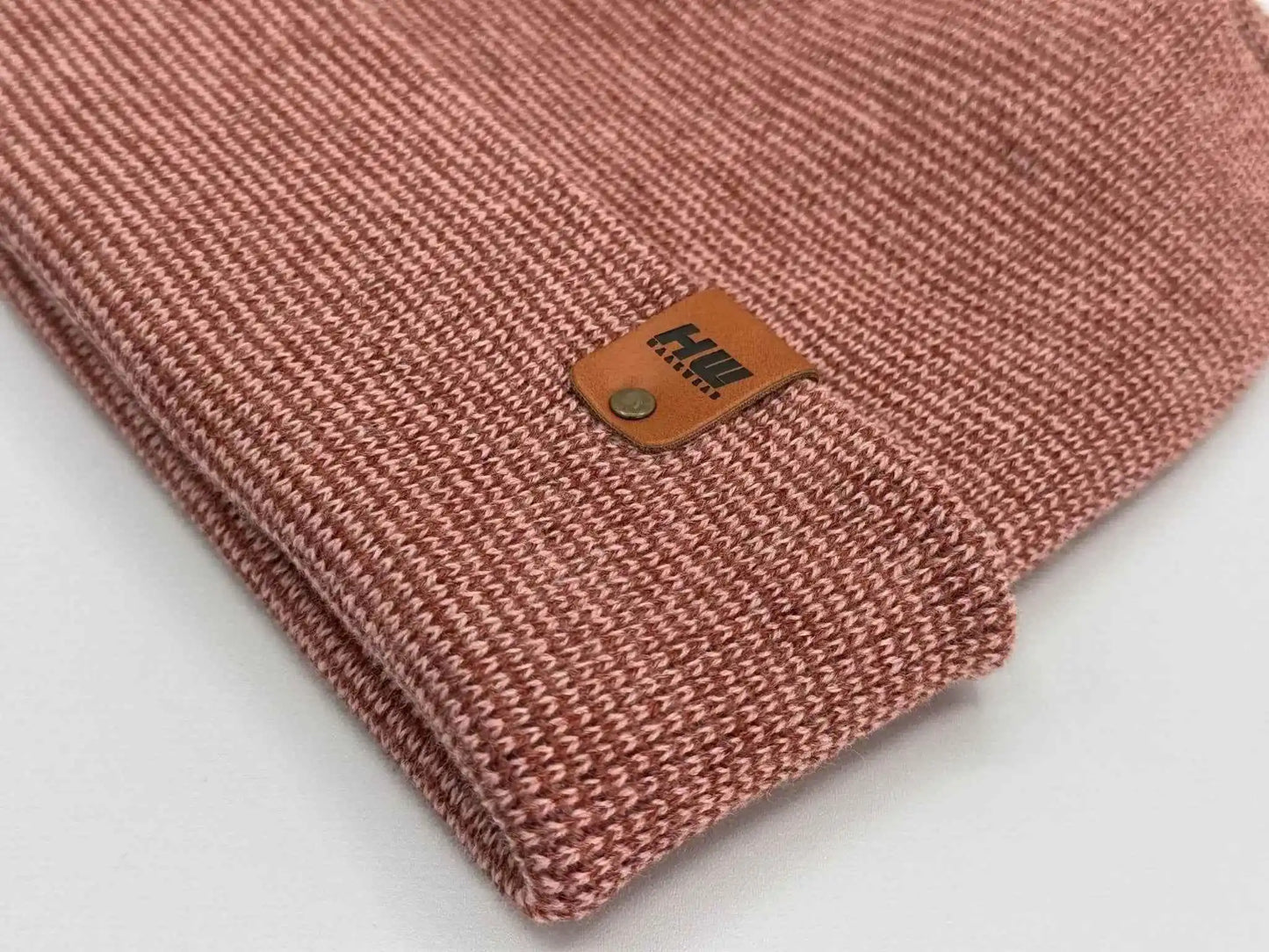 Burgundy cuffed beanie corner view with leather logo patch and knit texture