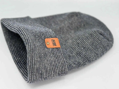 Gray cuffed beanie folded with orange logo patch on side